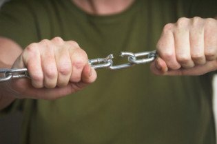 Woman breaking a chain