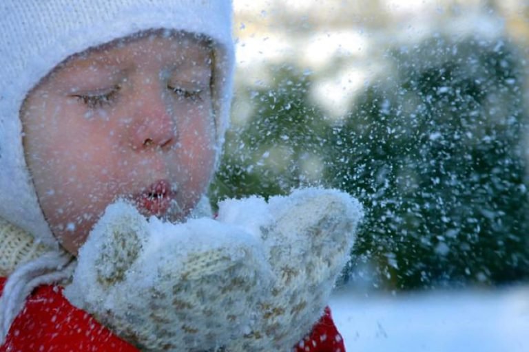 Child Blowing Snow From Mittens